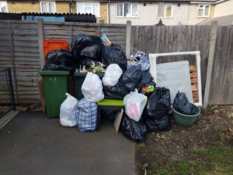 Cluttered garage before professional clearance